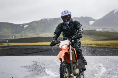 DirectAsia Insurance_motorcyclist on his bike riding on wet grounds